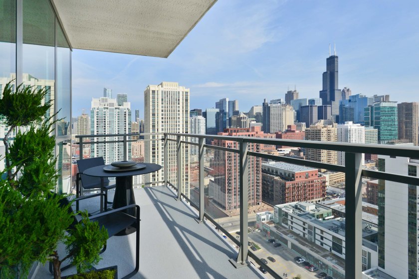 A simple outdoor balcony overlooking a major metropolitan city (in this case, Chicago).